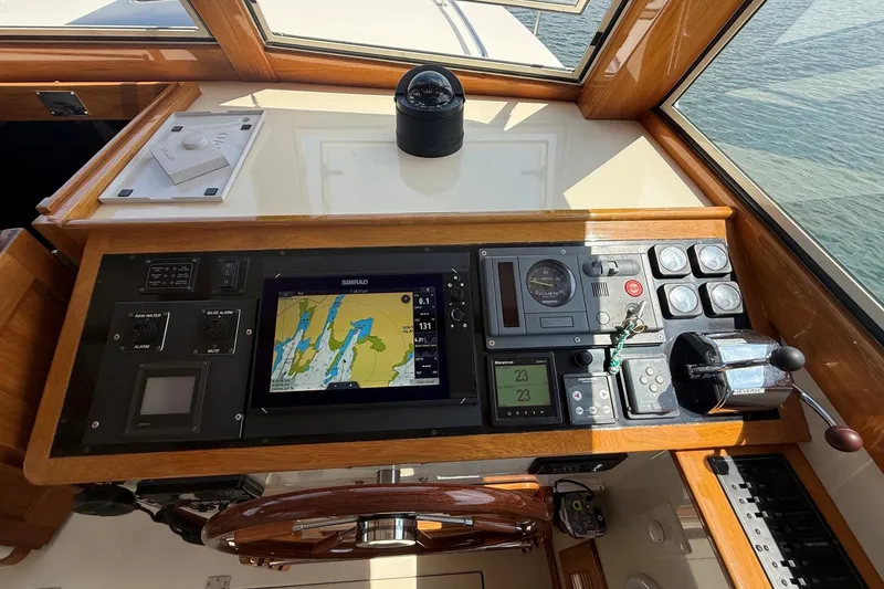 Slide: The Image of Control panel of a 2003 Ellis 36 Express Cruiser with navigation and steering equipment. - 43