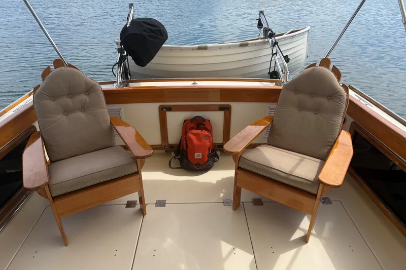Slide: The Image of 2003 Ellis 36 Express Cruiser interior with cushioned chairs and a red backpack. - 42