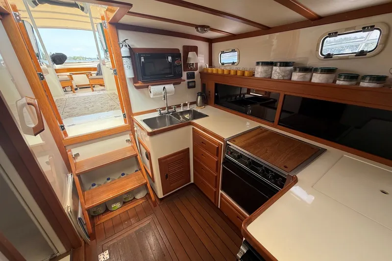 Slide: The Image of 2003 Ellis 36 Express Cruiser kitchen with wooden cabinetry and modern appliances. - 22