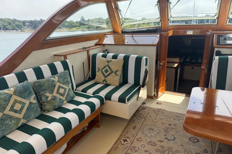 Slide: The Image of Luxurious interior of a 2003 Ellis 36 Express Cruiser with striped seating and decorative pillows. - 35