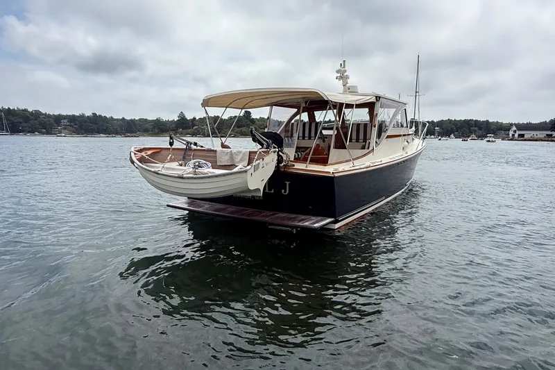 Slide: The Image of 2003 Ellis 36 Express Cruiser on calm water, featuring elegant design and spacious deck. - 3