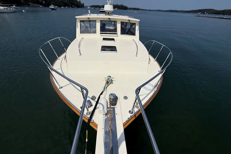 Slide: The Image of 2003 Ellis 36 Express Cruiser on calm water, showcasing its sleek design and spacious deck. - 6