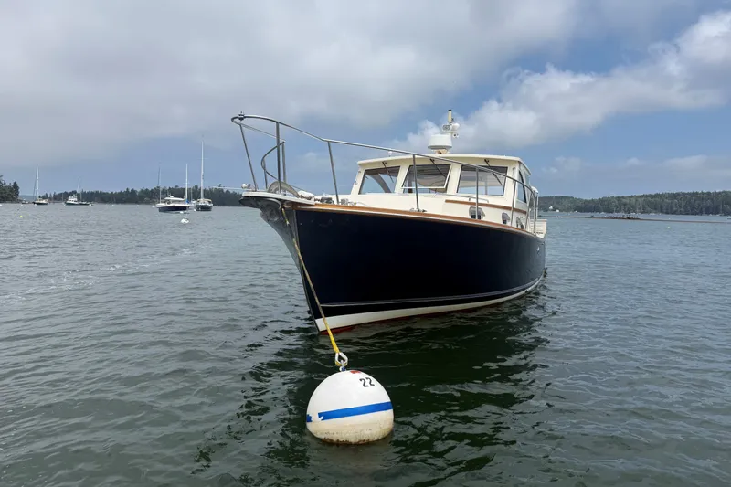 Slide: The Image of 2003 Ellis 36 Express Cruiser anchored on a calm lake with a buoy. - 2
