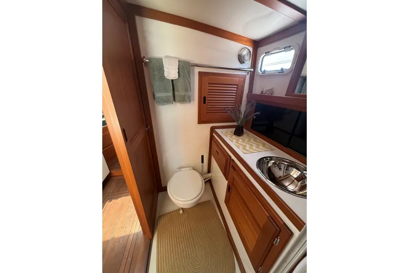 Slide: The Image of Bathroom interior of 2003 Ellis 36 Express Cruiser with wooden cabinetry and stainless steel sink. - 31