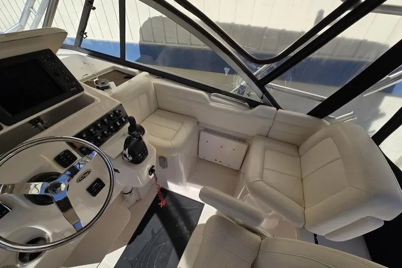 Slide: The Image of 2017 Grady-White Express 330 boat interior with steering wheel and seating area. - 20