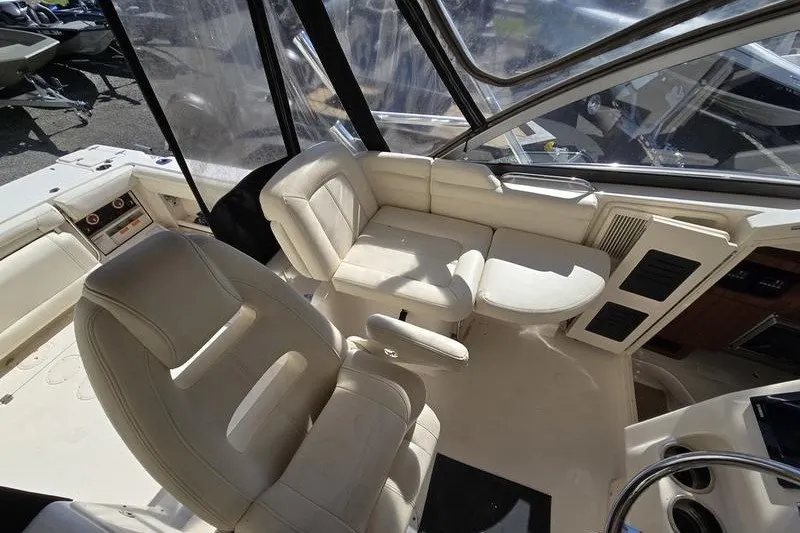Slide: The Image of 2017 Grady-White Express 330 boat interior with beige seating and helm area. - 25
