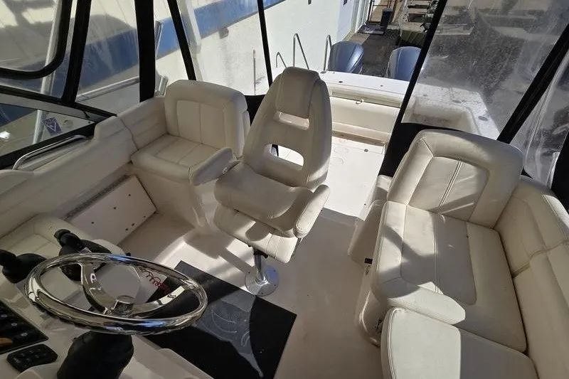 Slide: The Image of 2017 Grady-White Express 330 boat interior with white seating and steering wheel. - 22