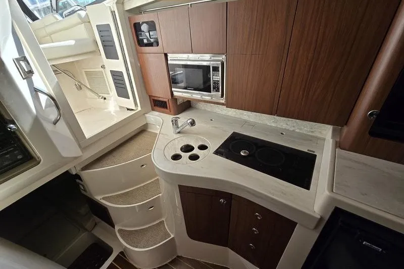 Slide: The Image of 2017 Grady-White Express 330 boat interior with kitchenette and stairs. - 14
