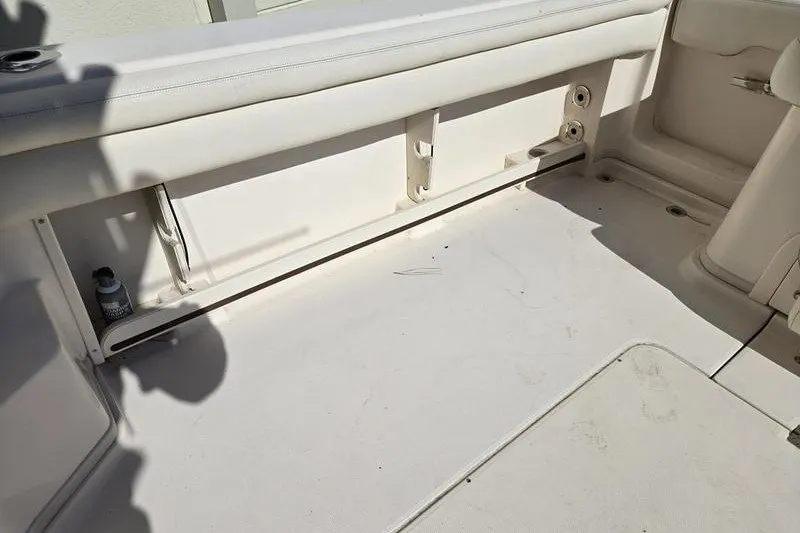 Slide: The Image of 2017 Grady-White Express 330 boat interior with white seating and storage compartments. - 19