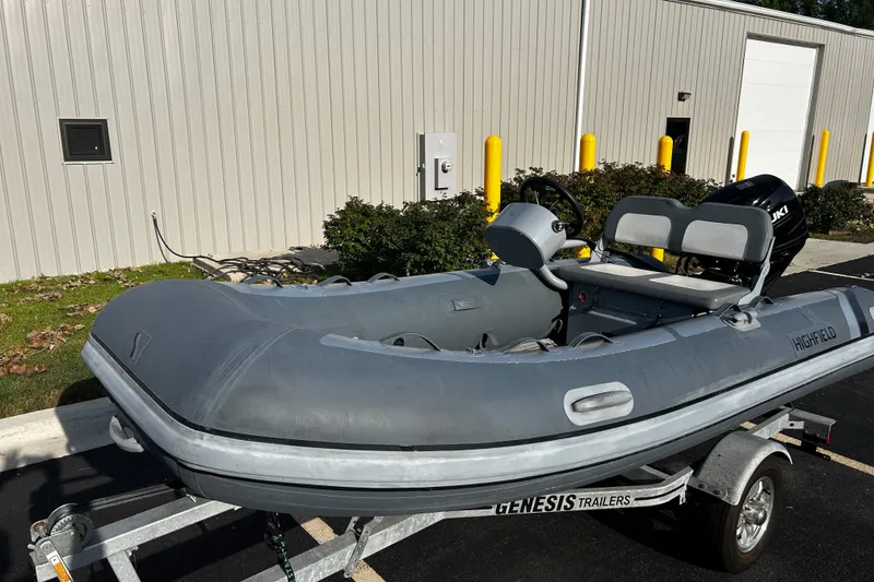 The Image of 2022 Highfield Classic 360 FCT inflatable boat on trailer, parked outside a building. - 0
