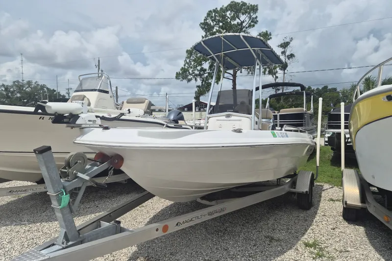 The Image of 2007 Triumph 190 Bay boat on trailer, parked outdoors under cloudy sky. - 1
