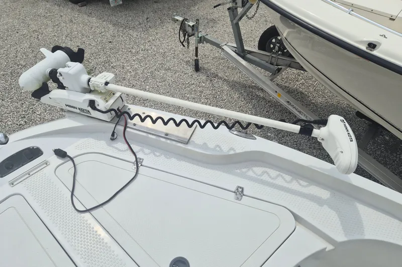 Slide: The Image of 2007 Triumph 190 Bay boat with Minn Kota trolling motor on gravel surface. - 21