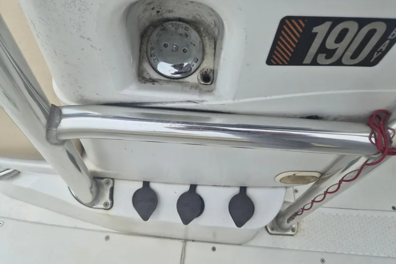 Slide: The Image of Close-up of a 2007 Triumph 190 Bay boat dashboard with controls and branding. - 15