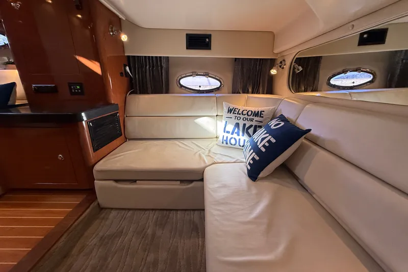 Slide: The Image of Interior of 2005 Regal Commodore 3560 IO yacht with cozy seating and decorative pillows. - 61