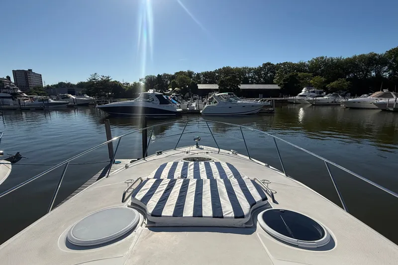 Slide: The Image of 2005 Regal Commodore 3560 IO yacht docked in a serene marina setting. - 31