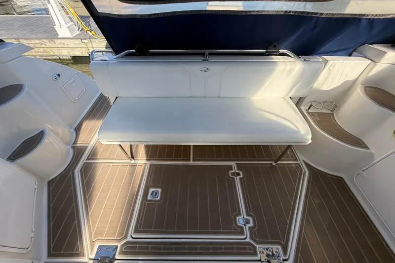 Slide: The Image of 2005 Regal Commodore 3560 IO boat interior with white seating and wood-patterned flooring. - 11