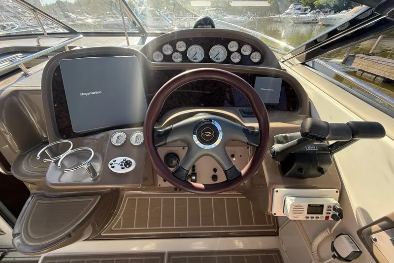 Slide: The Image of Helm of 2005 Regal Commodore 3560 IO with Raymarine navigation system and controls. - 25