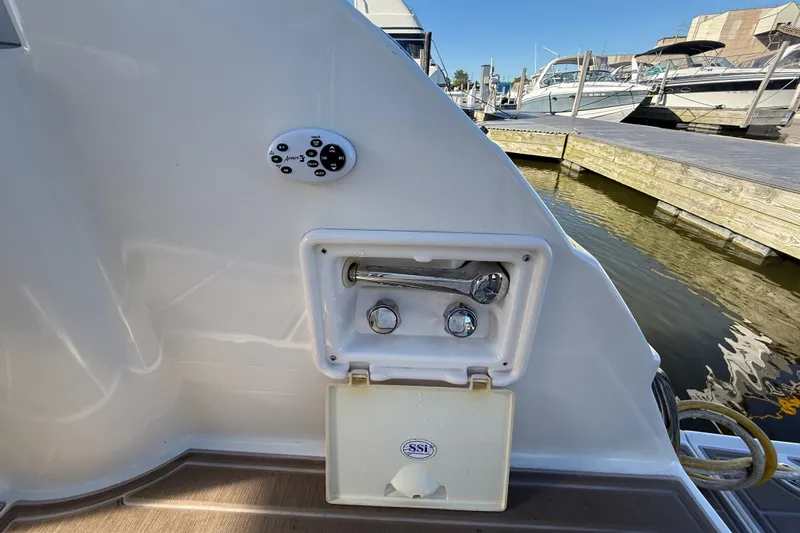 Slide: The Image of 2005 Regal Commodore 3560 IO boat deck with control panel and dock view. - 8