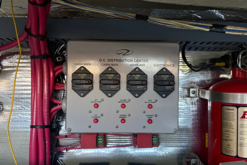 Slide: The Image of Electrical panel of a 2005 Regal Commodore 3560 IO boat with wiring and fire extinguisher. - 69