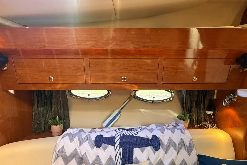 Slide: The Image of Interior of 2005 Regal Commodore 3560 IO with wooden cabinets and nautical decor. - 37