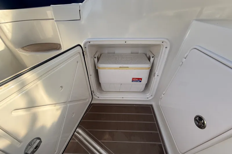 Slide: The Image of Open storage compartment on 2005 Regal Commodore 3560 IO boat with Igloo cooler inside. - 13