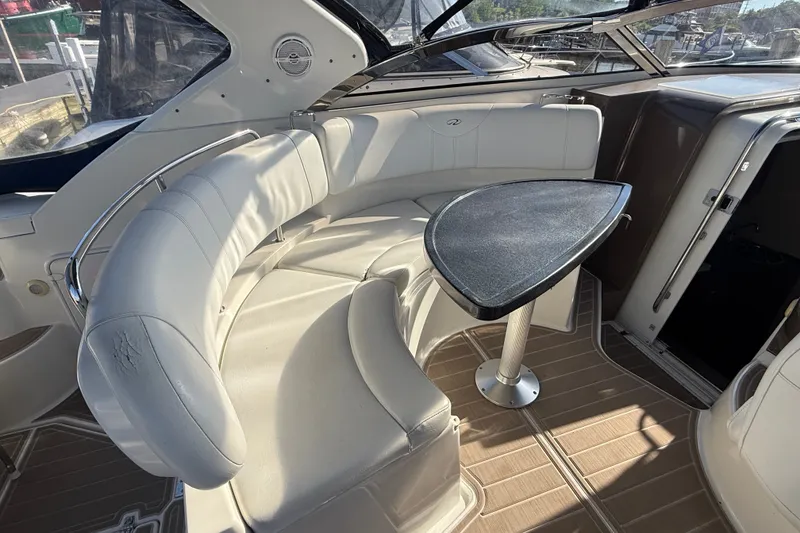 Slide: The Image of 2005 Regal Commodore 3560 IO boat interior with curved seating and table. - 20
