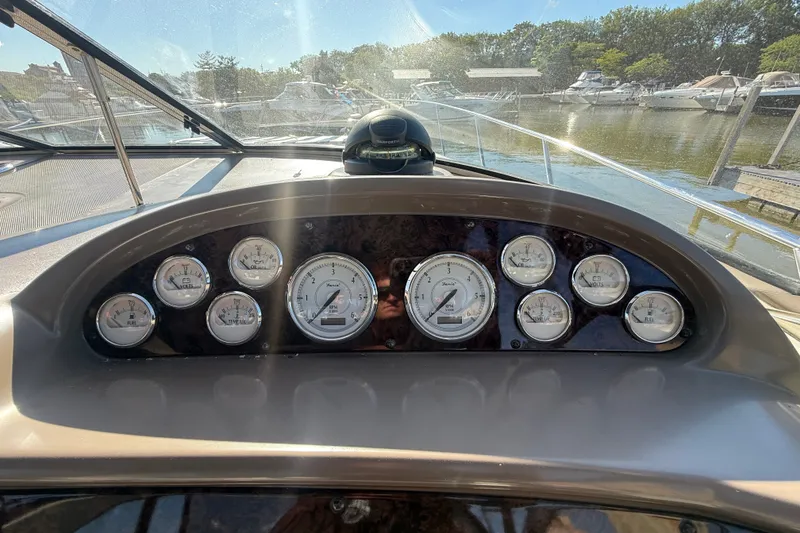 Slide: The Image of Dashboard of a 2005 Regal Commodore 3560 IO boat with various gauges and controls. - 26
