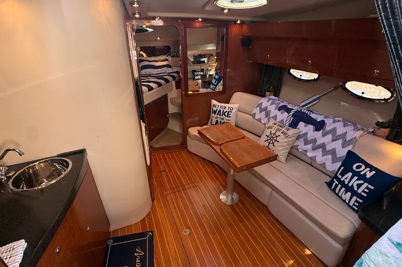 Slide: The Image of Interior of 2005 Regal Commodore 3560 IO yacht with cozy seating and nautical decor. - 33