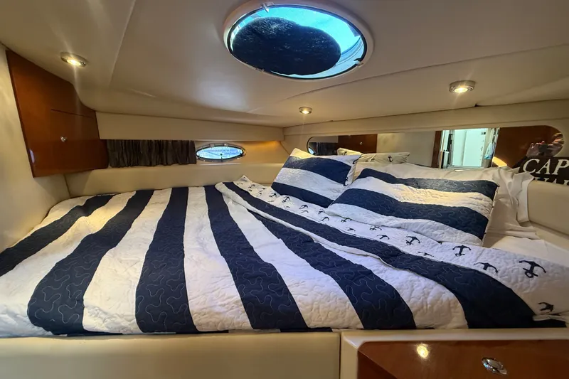Slide: The Image of Luxurious cabin interior of 2005 Regal Commodore 3560 IO yacht with striped bedding. - 50