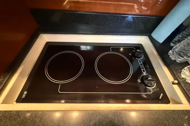 Slide: The Image of Built-in stovetop on 2005 Regal Commodore 3560 IO yacht, featuring dual burners and sleek design. - 45