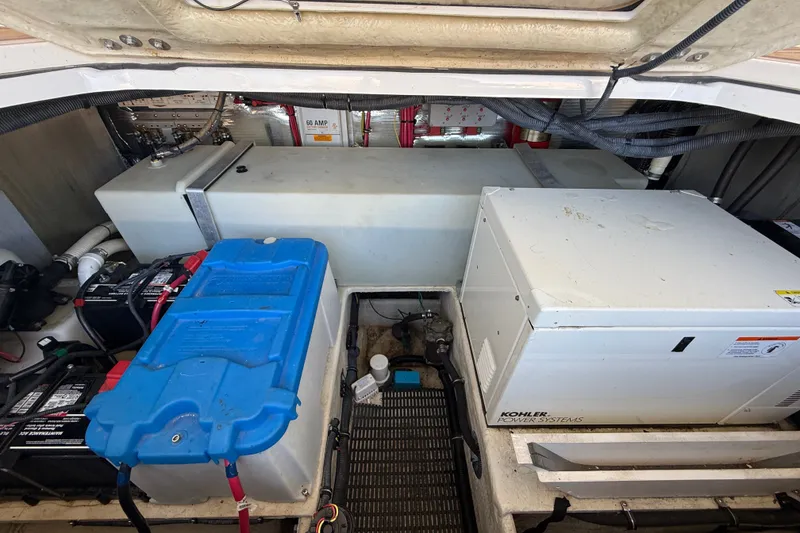 Slide: The Image of Engine compartment of a 2005 Regal Commodore 3560 IO with batteries and Kohler power system. - 66