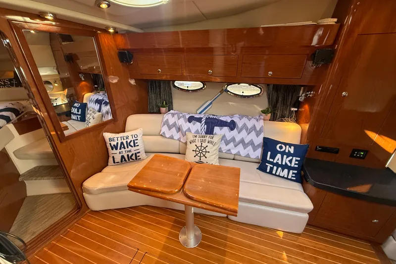 Slide: The Image of Interior of 2005 Regal Commodore 3560 IO yacht with cozy seating and nautical decor. - 34