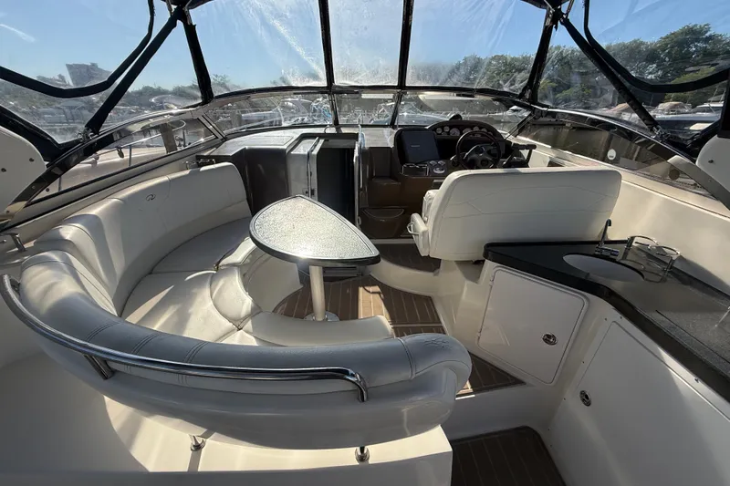 Slide: The Image of 2005 Regal Commodore 3560 IO yacht interior with seating, table, and helm. - 19