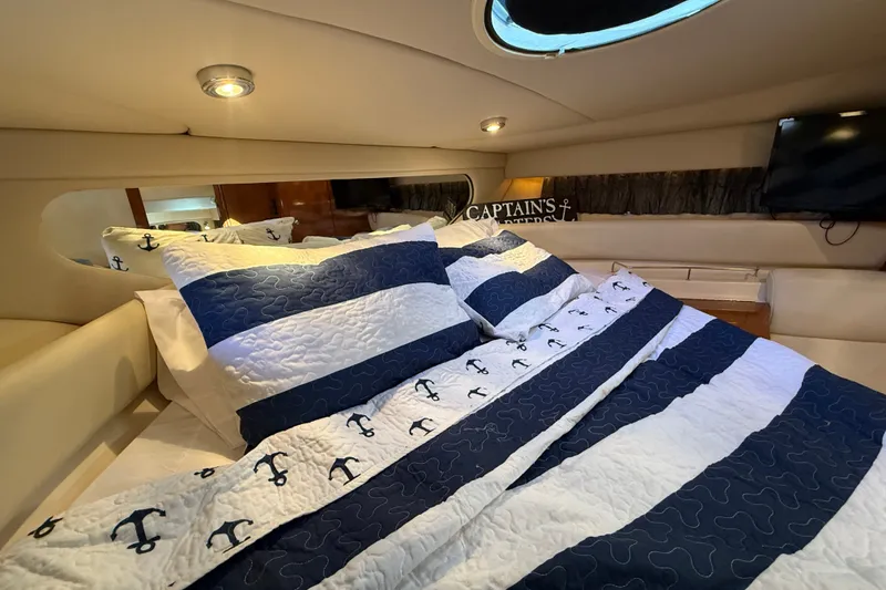 Slide: The Image of Luxurious cabin interior of 2005 Regal Commodore 3560 IO with nautical-themed bedding. - 51