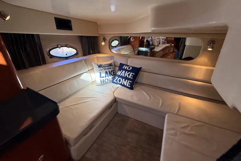 Slide: The Image of Interior of 2005 Regal Commodore 3560 IO yacht with cozy seating and decorative pillows. - 58