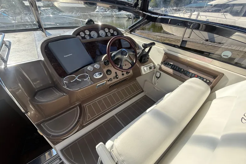 Slide: The Image of Cockpit of 2005 Regal Commodore 3560 IO boat with steering wheel and control panel. - 23