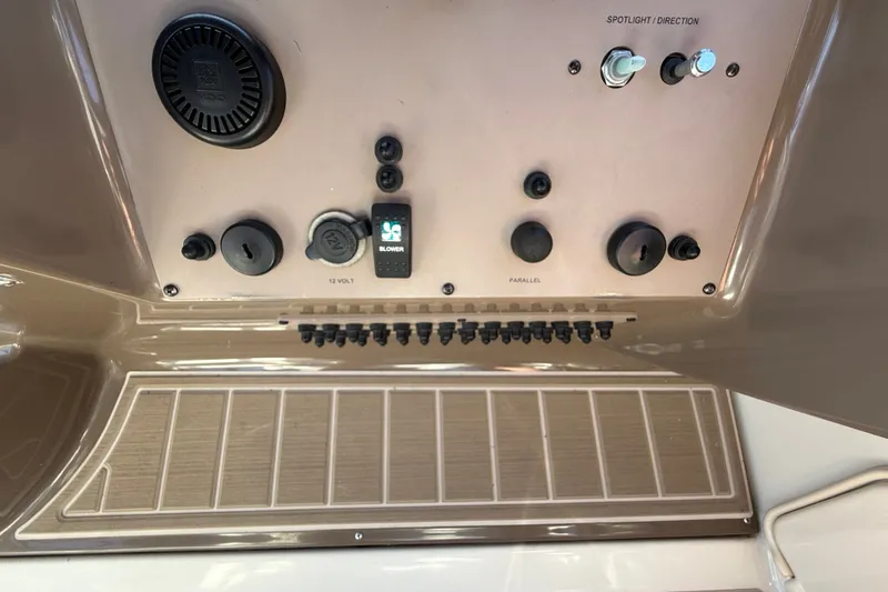 Slide: The Image of Control panel of a 2005 Regal Commodore 3560 IO boat with switches and dials. - 28