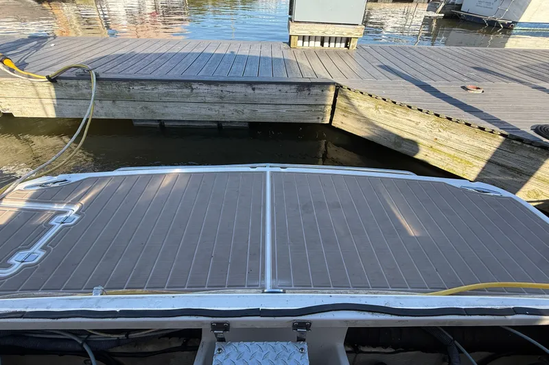 Slide: The Image of 2005 Regal Commodore 3560 IO boat docked at a wooden pier. - 70