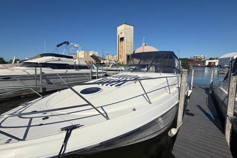 Slide: The Image of 2005 Regal Commodore 3560 IO yacht docked at marina under clear blue sky. - 5