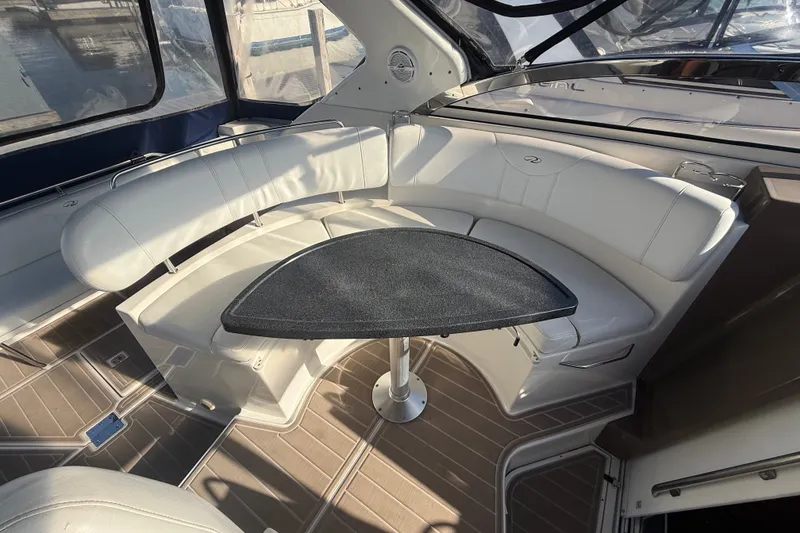 Slide: The Image of 2005 Regal Commodore 3560 IO boat interior with white seating and a black table. - 21