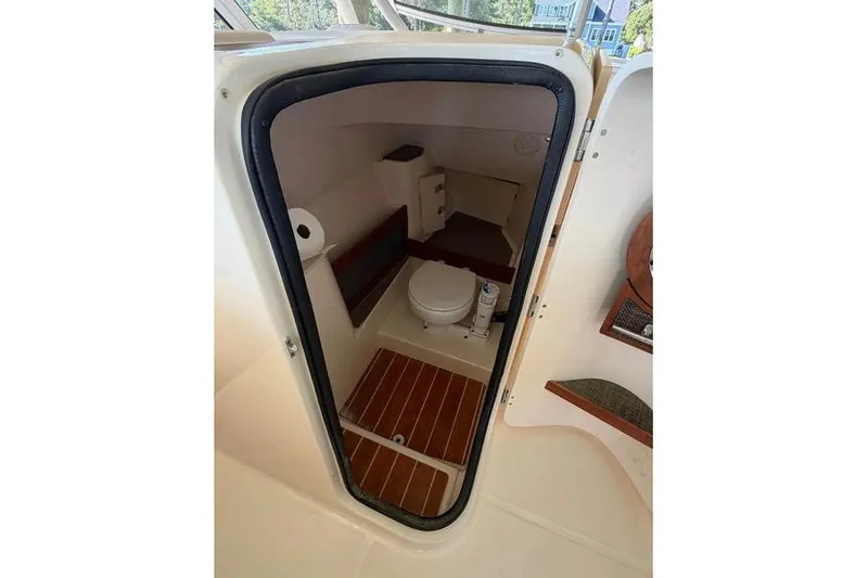 Slide: The Image of 2024 Grady-White Freedom 285 boat interior with compact marine toilet. - 47