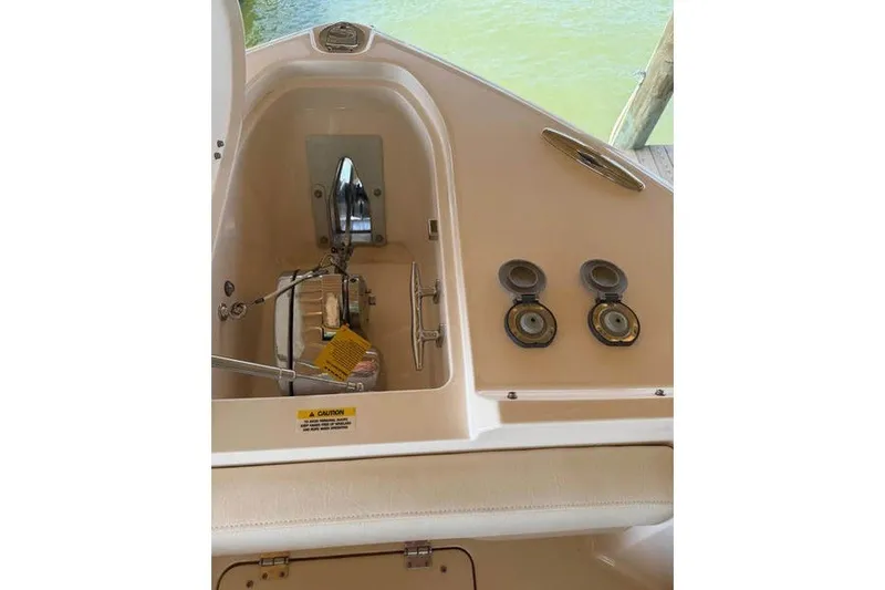 Slide: The Image of 2024 Grady-White Freedom 285 boat anchor compartment with dual hatches and marine fittings. - 26