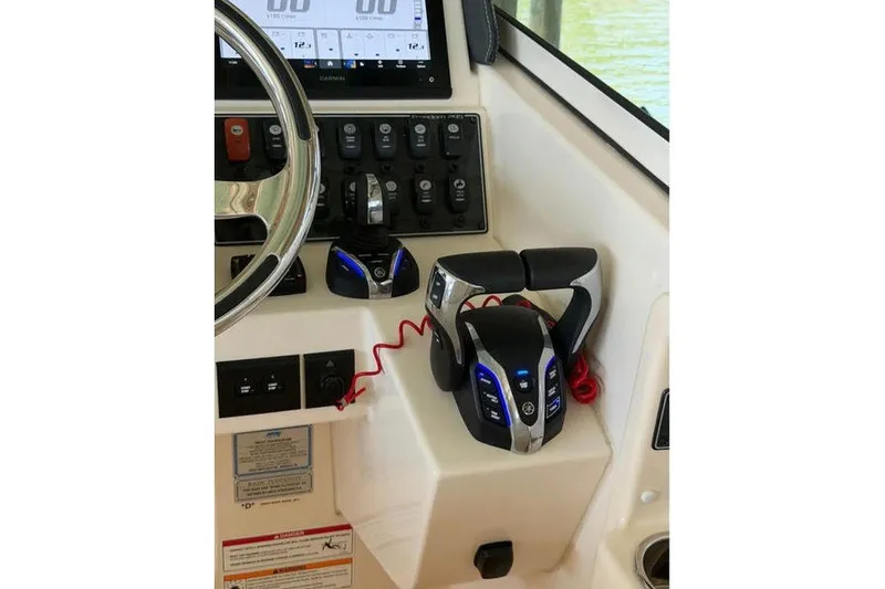 Slide: The Image of 2024 Grady-White Freedom 285 helm with modern controls and navigation display. - 11