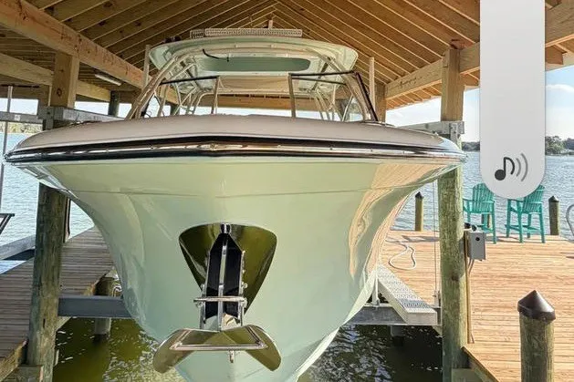 Slide: The Image of 2024 Grady-White Freedom 285 boat docked under a wooden shelter. - 32