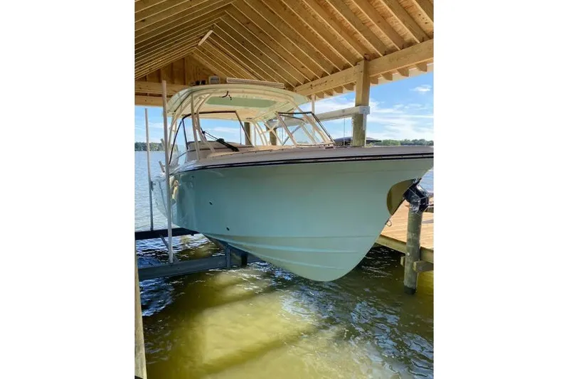 The Image of 2024 Grady-White Freedom 285 boat docked under wooden shelter. - 1