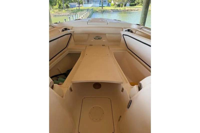 Slide: The Image of 2024 Grady-White Freedom 285 boat interior with open storage compartments, dockside view. - 34