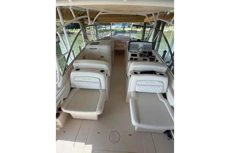 Slide: The Image of 2024 Grady-White Freedom 285 boat interior with luxurious seating and helm station. - 16