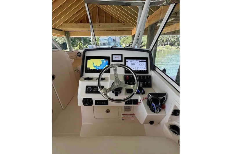 Slide: The Image of 2024 Grady-White Freedom 285 helm with advanced navigation displays and controls. - 44