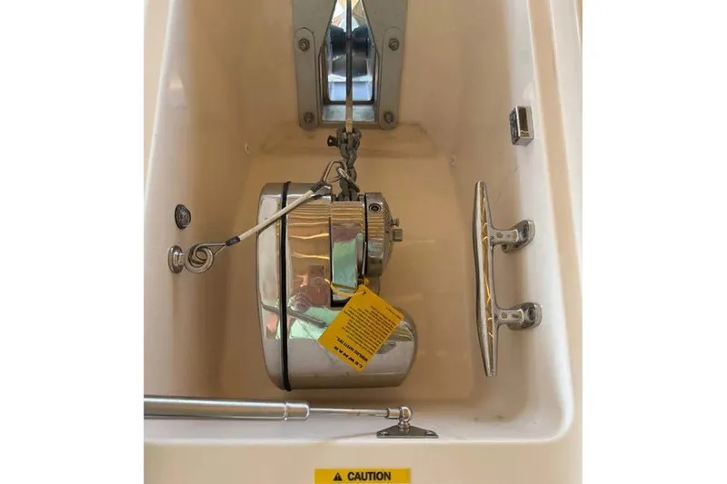 Slide: The Image of Anchor compartment of 2024 Grady-White Freedom 285 boat, featuring stainless steel components. - 33