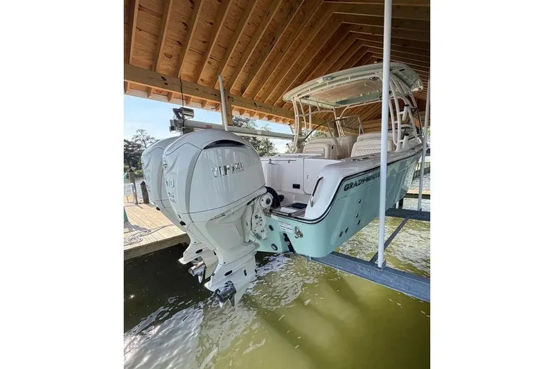 Slide: The Image of 2024 Grady-White Freedom 285 boat with Yamaha outboard motor in a covered dock. - 2